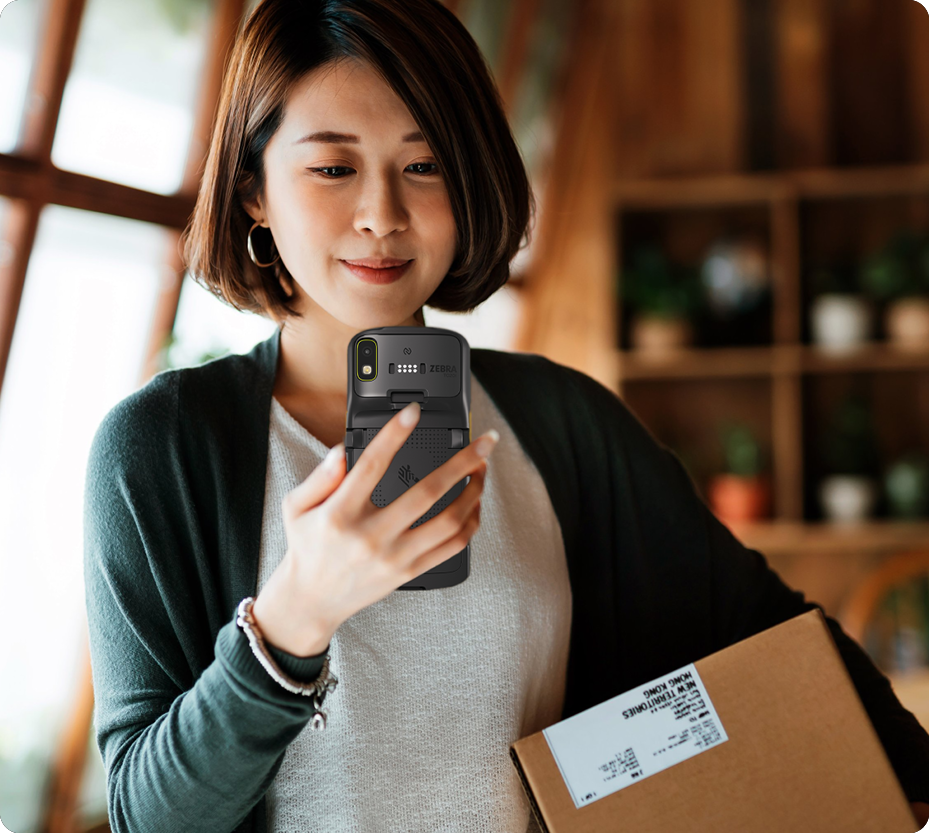 Associate checking a package with a Zebra handheld
